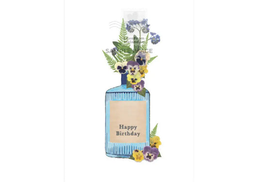 a postcard dipicting flowers in a Drumshanbo Gin bottle with a label that says Happy Birthday