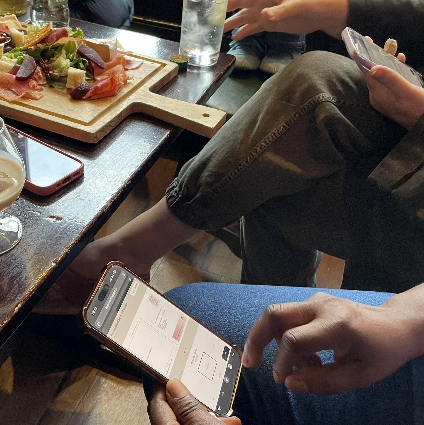 Photowalk participants sitting together to review shots and create personal postcards in a local bar