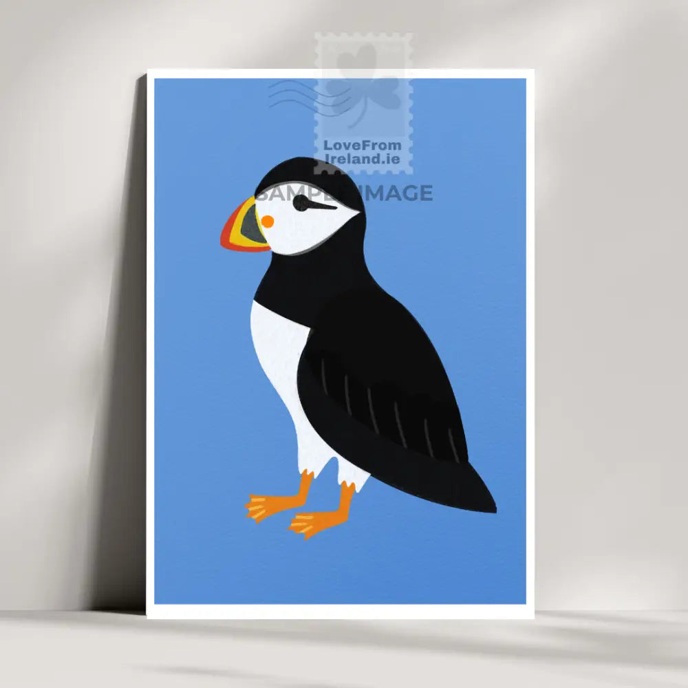 Puffin postcard by artist Rachel Rothwell featuring a puffin on a plain blue background