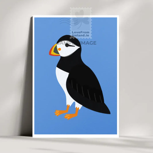 Puffin postcard by artist Rachel Rothwell featuring a puffin on a plain blue background